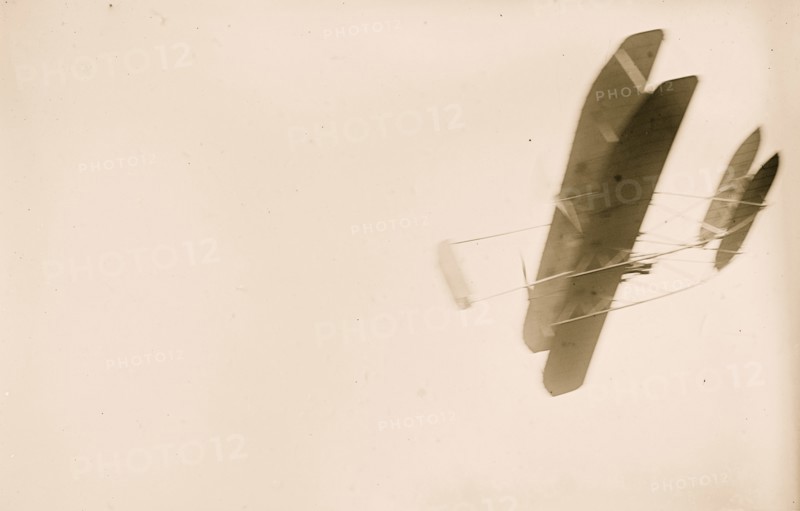 Orville Wright flying in his airplane 1908