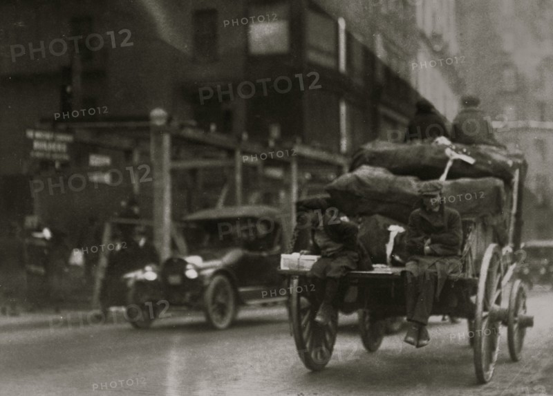 P.M. Delivery boys on Tremont Street, "getting a hitch." 1917