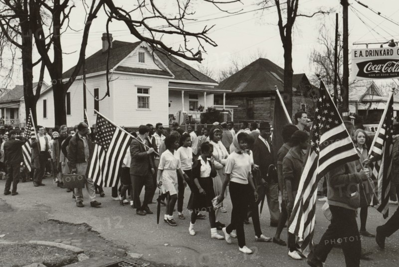 Participants, some carrying American flags, marching in the civil rights march from Selma to Montgomery, Alabama in 1965 1965