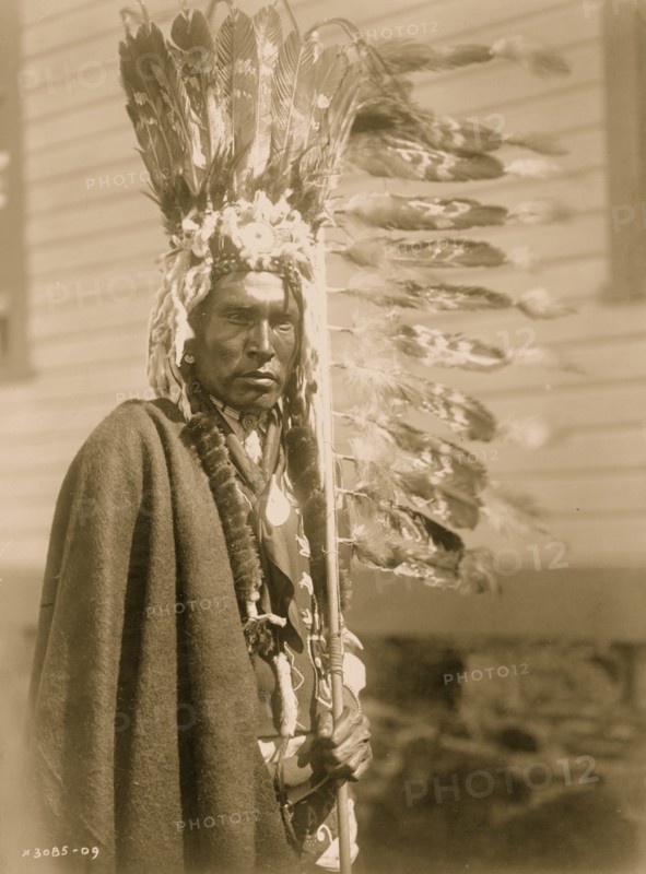 Piegan war-bonnet and coup-stick 1910