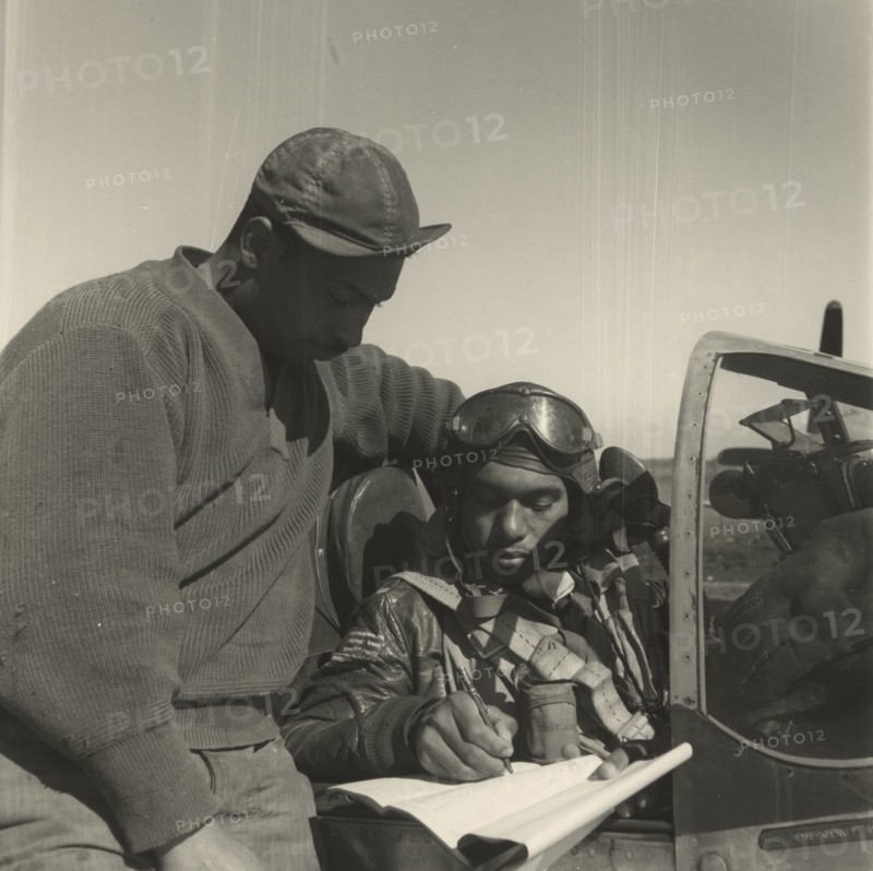 Pilot from the 332nd Fighter Group signing Form One Book 1945