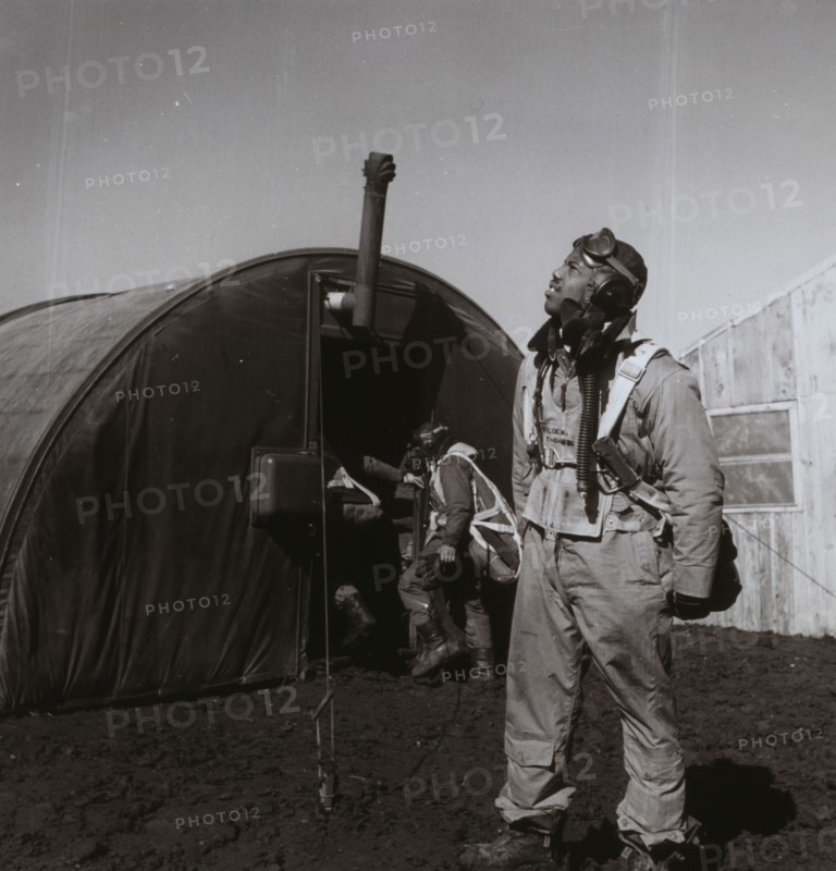 Black fighter pilot series--pilot with parachute room in background, Ramitelli, Italy 1945