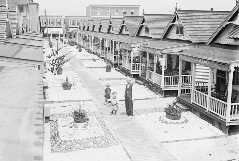 Porches and front lawns of row of bungalows, Rockaway, N.Y.