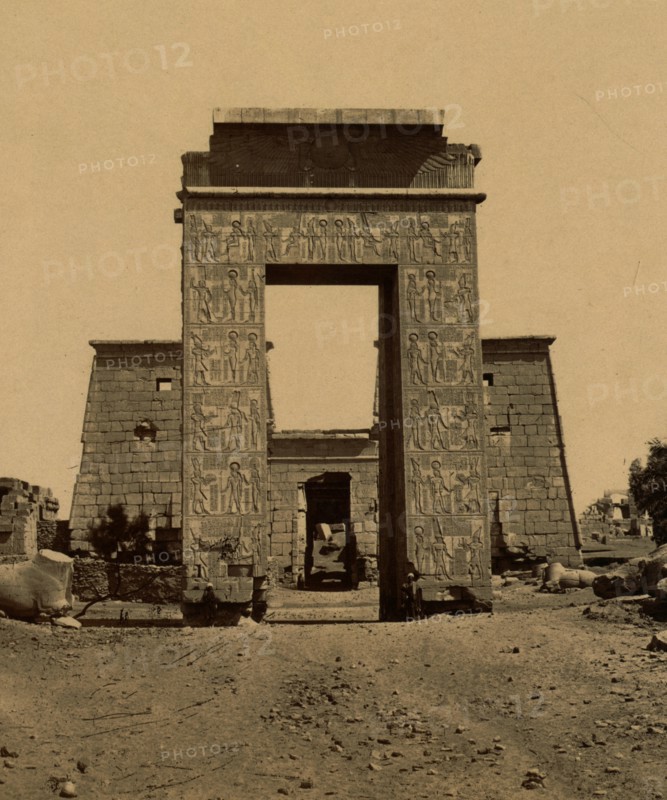 Propylon (triumphal arch) and pylon in the Valley of the Rams, part of the Temple of Ramses IV in Thebes. 1880