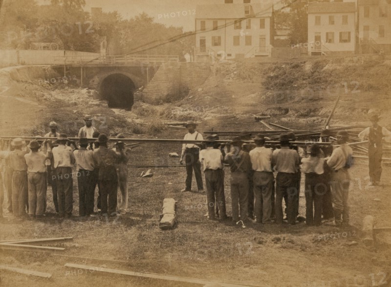 Railroad construction workers straightening track 1863