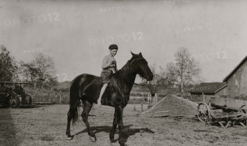 Riding a horse on the family farm 1916