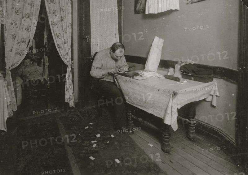 Rolling cigarette cases in tenement home. 1912