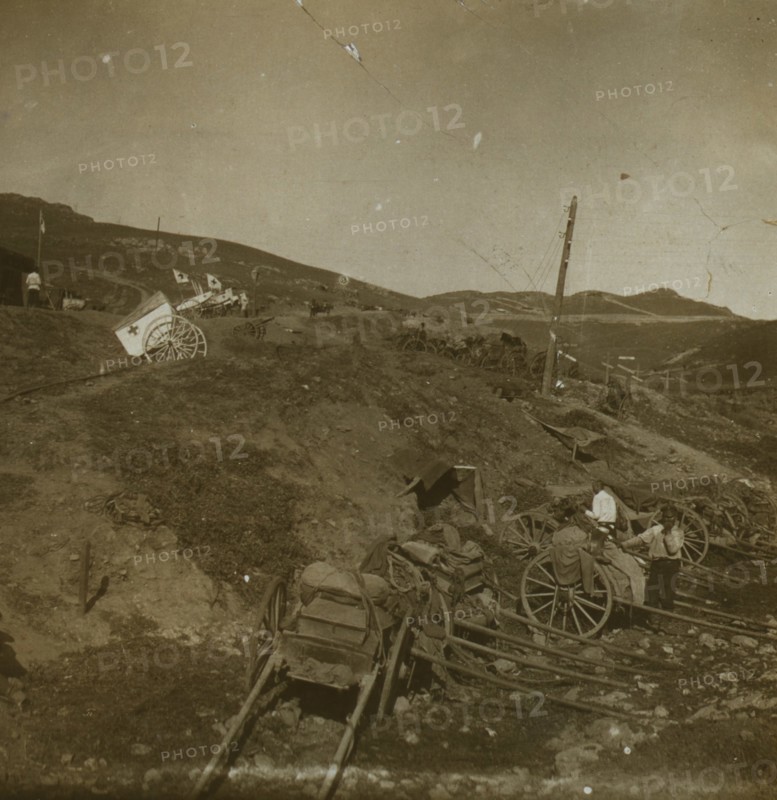 Russian supply carts at the base of a hill; on the hill, a Red Cross field post with wagons for transporting the wounded 1905