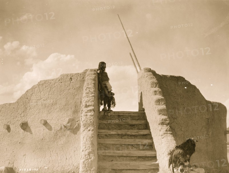 Tewa Indian guard at top of the kiva stairs, San Ildefonso, New Mexico 1905