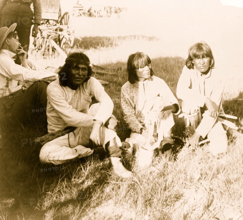Thrasher and three Indians sitting outdoors 1901