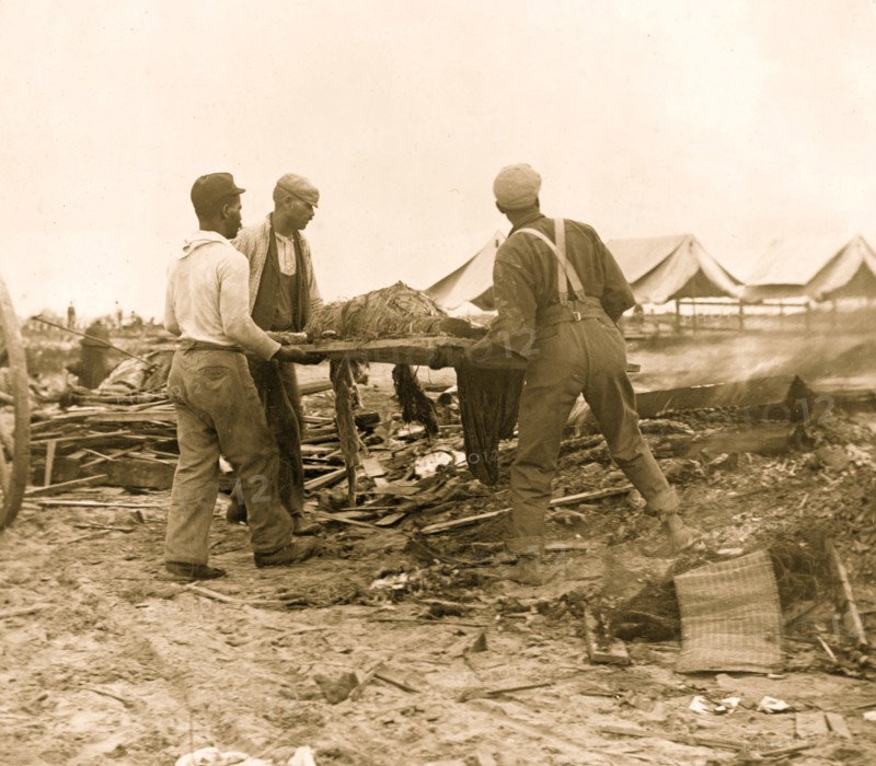 Galveston disaster, carrying dead body to fire to be burned 1900