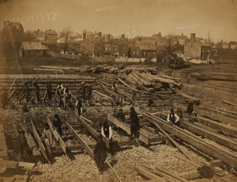 Track near the Potomac River, in Alexandria. Lumber; part of construction force at work 1863