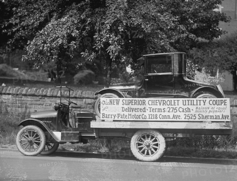 Truck carries a Chevrolet Coupe Advertisement with an actual vehicle on board 1922