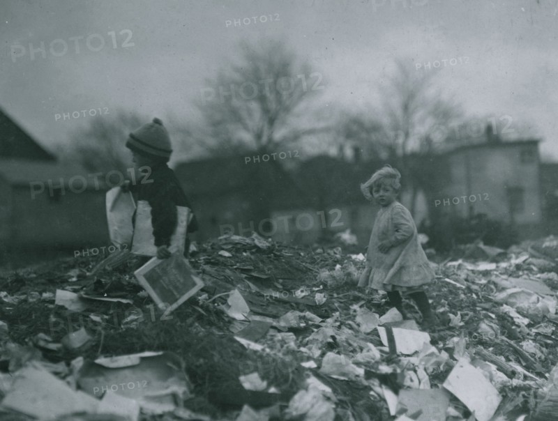 Two children going through the "Dumps." Location 1912