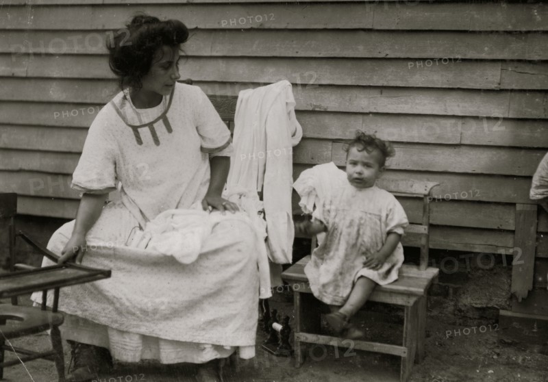Mother & Children doing typical  home work on underwear 1912