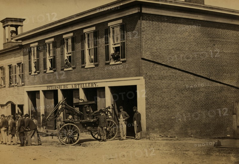 Union soldiers pull a fire engine from a garage designated Petersburg artillery 1863