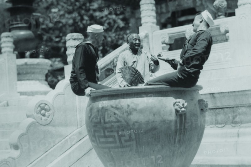 US Navy Sailors on Shore Leave in Beijing frolic in Giant Ceramic Pot with Guide