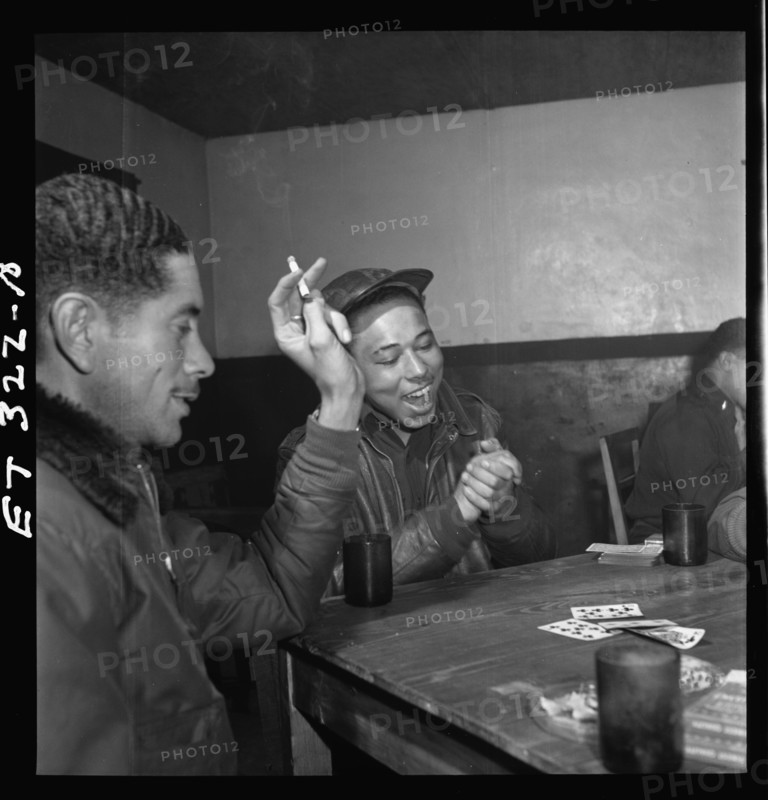 Tuskegee airmen playing cards in the officers' club in the evening 1945