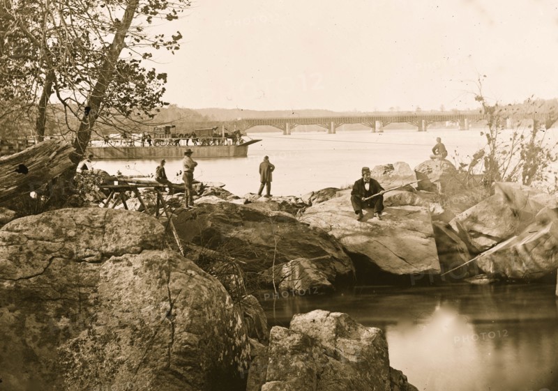 Georgetown ferry-boat carrying wagons, and Aqueduct Bridge beyond, from rocks on Mason's Island 1863