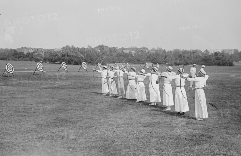 Woman's Archery Team Fires Arrows at a line of targets