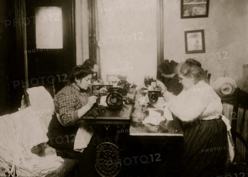 Workers on gloves, crowded into a small kitchen. Dallavalla, 50 McDougal St. 1912