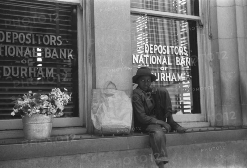 Young Black flower vendor, Durham, North Carolina 1940