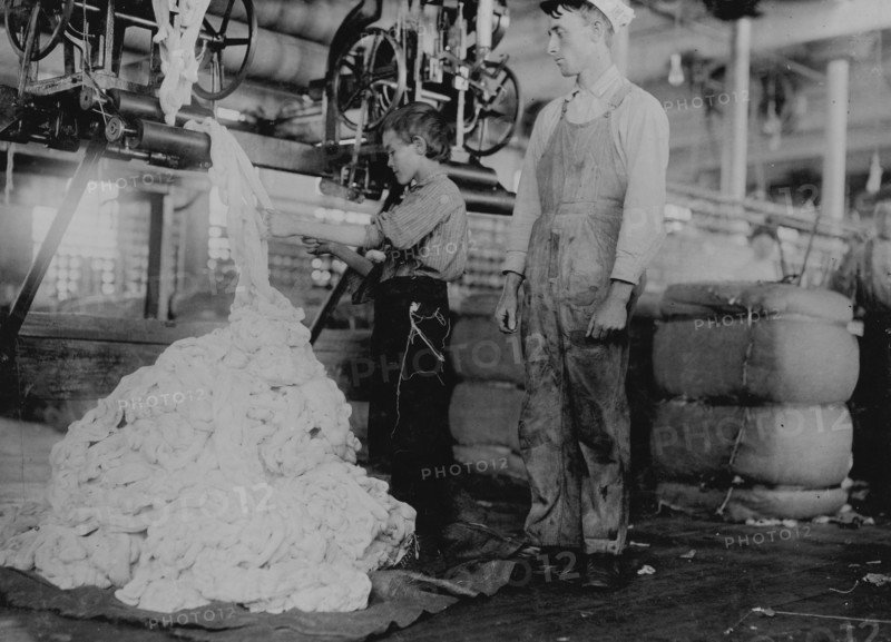Young boy on warping machine Elk Cotton Mills. 1910