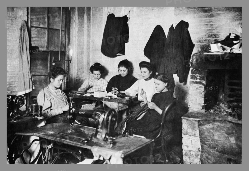 Five Immigrant Women Sit at a Table and Sew 1900
