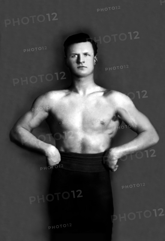 Bodybuilder in Pants with Bared Torso