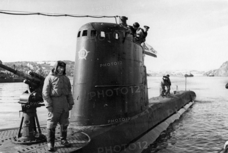 Northern fleet, hero of the soviet union, commander i, fisanovich stands by the gun watching 'baby' being moored.