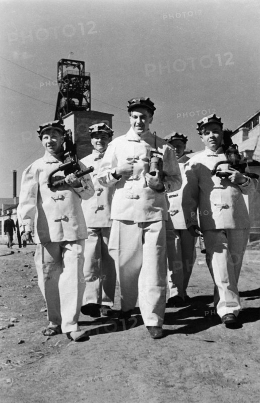Alexander molodchenko (center) with fellow miners at the kaganovich mines in the krivoi rog fields, ussr, 1949.