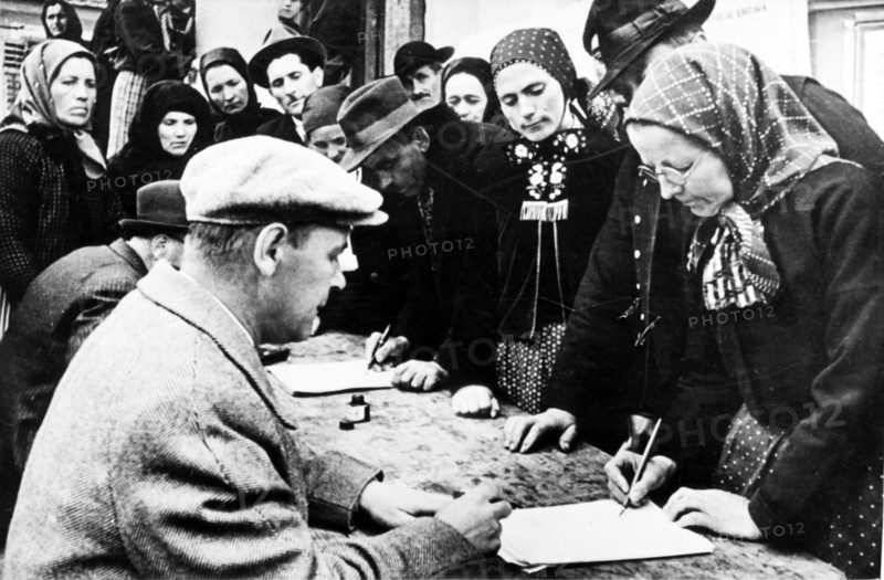 Collective farmers signing the appeal for the conclusion of a five-powers peace pact in romania, 1952.