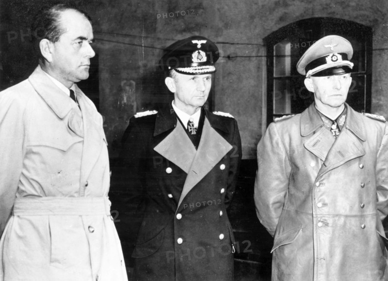 Albert speer (l), hitler's minister of production, grand admiral doenitz and general jodl, seen after their arrest in a courtyard at flemsburg, seat of doenitz government, 1945.