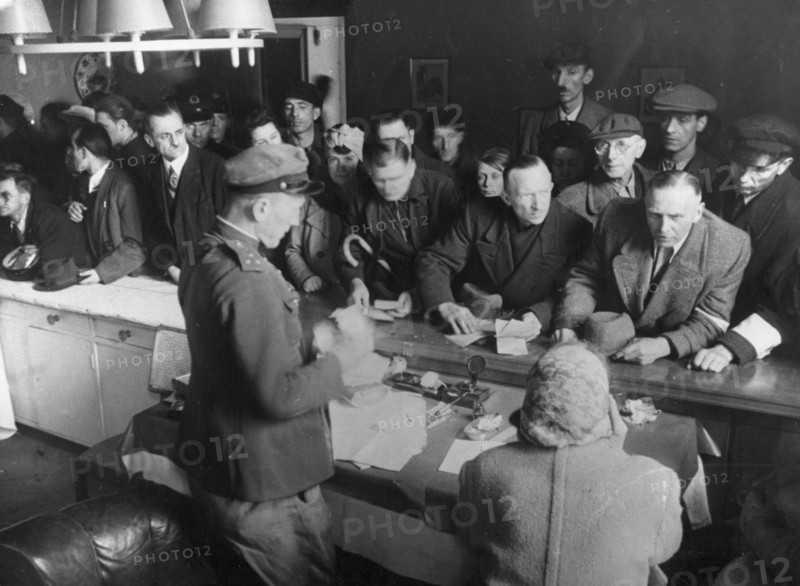 Captain kazakov receiving german civilians in the soviet military commandant's office in weissensee district, 1945.