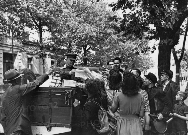 Distributing german newspapers to the population of berlin, 1945 or 1946.