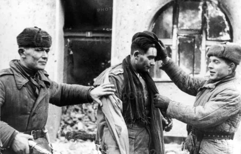 The german officer, who tried to escape in civilian dress, was taken prisoner by these two soviet tommy-gunners.