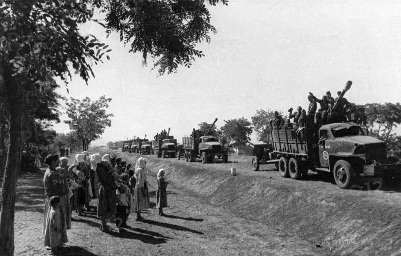 A column of soviet troops passing a group of romanian villagers during world war ll, september 1944, the trucks are american, sent as part of the lend-lease program.