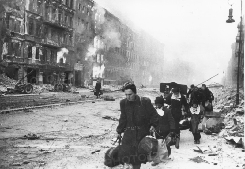 German civilians fleeing berlin under the red army attack, world war 2, city in ruins, 1945.