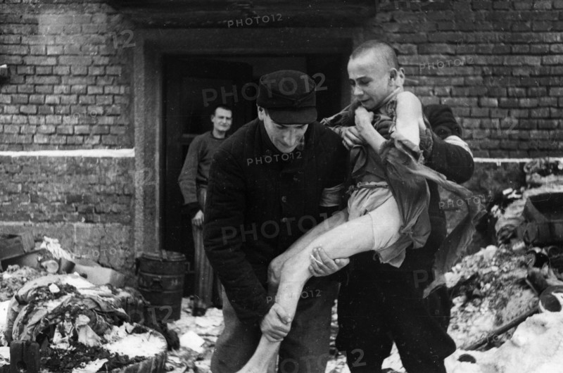 A 15 year old russian boy, ivan dudnik, who was brought to auschwitz from his home in the orel region by the nazis, being rescued, he has gone insane from witnessing the horrors of the camp, february 1945.