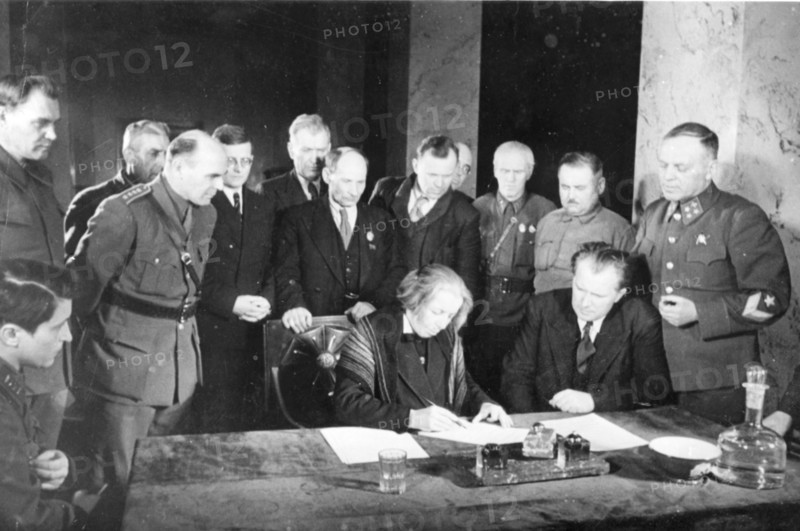 Second all-slav meeting in moscow, signing a message to the slavic peoples: at the table, stelia blagoeva, bulgarian leader (left), also pictured (l, to r,) are polish writer wanda wasilewska, composer dmitri shostakovich, croat leader duro salaj, byelorussian poet yakub kolas, yugoslav poet radule stijenski, leningrad writer nikolai tikhonov, warsaw writer alexandr ioczis, and others.