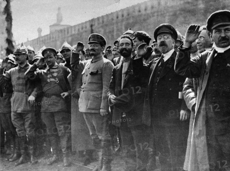 A parade in red square, moscow, soviet union, may 1st, 1922, left to right: mikhail lashevich (second from left), leon trotsky (center, military uniform, beard), lev kamenev (second from right), tomsky (far right).