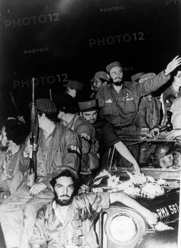 Newly victorious fidel castro ruz entering havana at the head of his revolutionary army, cuba, 1959, juan almeida bosque is behind him in profile.