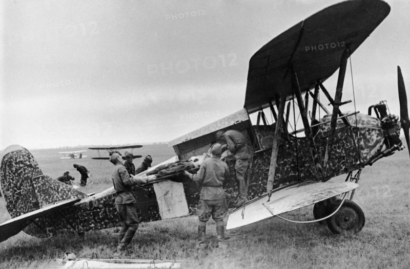 A wounded red army soldier being loaded into a polikarpov po-2 (u-2) plane during world war 2.