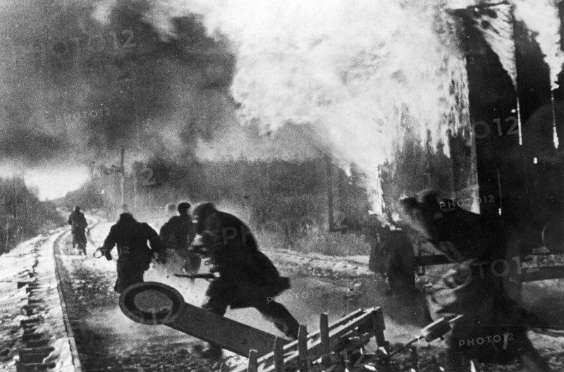 World war 2, russian partisans behind enemy lines setting fire to a freight train at a german supply depot.