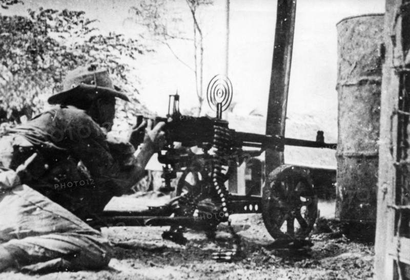 A nlf (national liberation front) fighter firing a machine gun at his post in sguemtri faun, in the village of mi tho, south vietnam, february 1969.