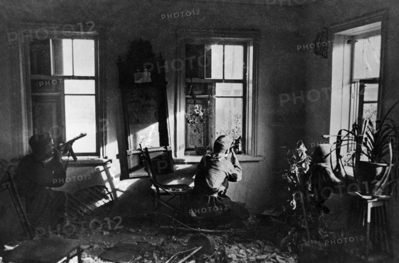 World war 2, battle of stalingrad, soviet tommy gunners snipe at the enemy from an ambush in a house.