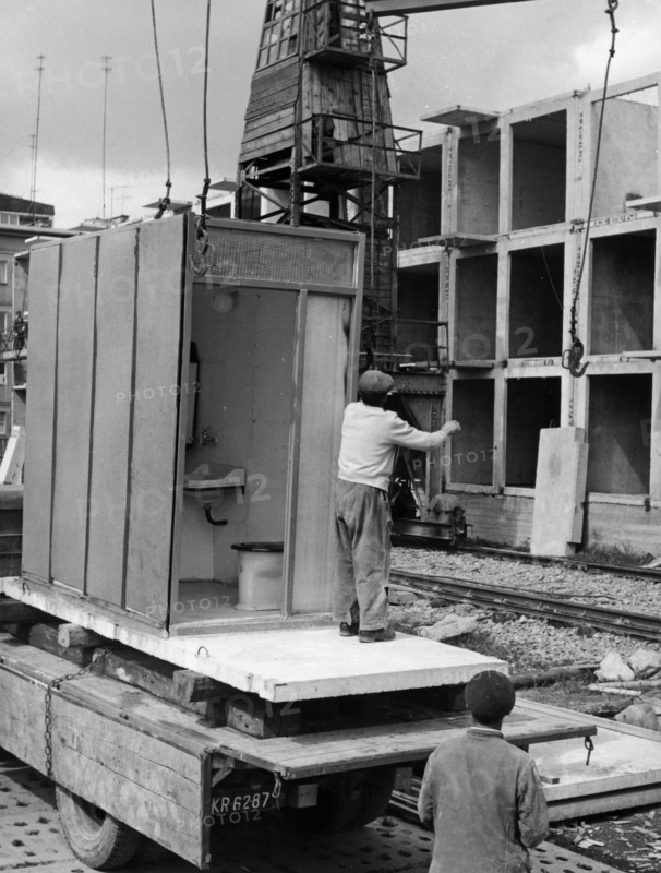 A prefab bathroom unit about to be put into place on a block of flats being constructed in nowa huta in the krakow province in poland, september 1962, these buildings are being constructed using an experimental method called 'dominoes' from precast units, only six workers are employed at this site.