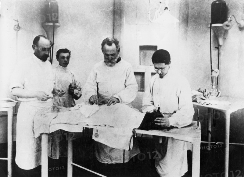 Ivan pavlov (second from right) in his laboratory, operating on one of his dogs.