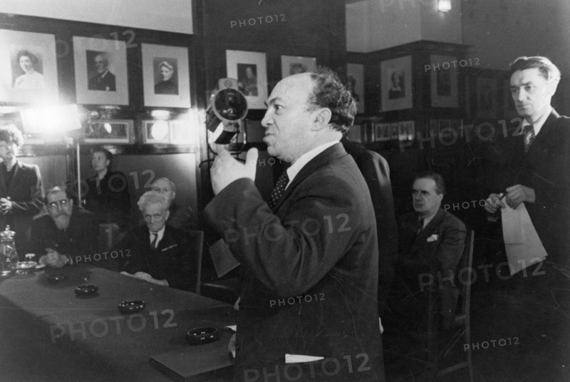 A special meeting of the stalin prize committee held at the moscow art theater where badges and diplomas were being presented to the soviet artists and writers who had been awarded stalin prizes for outstanding works completed in 1945, stalin prize laureate solomon mikhoels is congratulating the prize winners, may 1947.