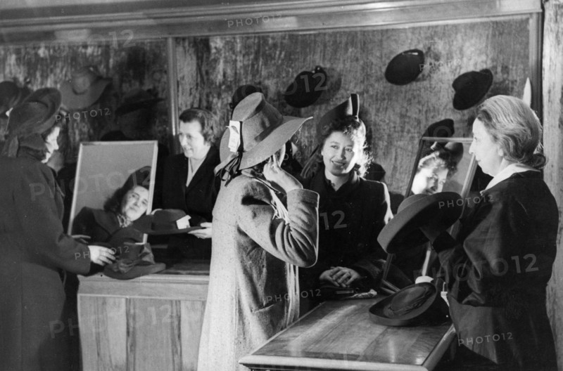 Women trying on hats at a millinery in moscow, april 1948.